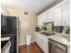 Efficient kitchen features ample white cabinetry, laminate countertops, stainless steel appliances, and wood-look flooring at 2433 Ne 7Th St # 3, Ocala, FL 34470