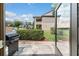 Back patio includes lush landscaping, a privacy wall, a barbecue grill, and ample space for outdoor dining at 2433 Ne 7Th St # 3, Ocala, FL 34470