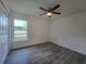 Bedroom featuring gray floors, ceiling fan and closet, with natural light through window at 263 Oak Lane Trak, Ocala, FL 34472