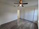 Bedroom with ceiling fan and gray floors leads to closet with double folding doors at 263 Oak Lane Trak, Ocala, FL 34472