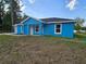Lovely blue single-story home with a welcoming entrance and well-placed windows at 263 Oak Lane Trak, Ocala, FL 34472