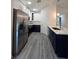 Kitchen featuring stainless steel appliances, new countertops, and a combination of navy and white cabinets at 263 Oak Lane Trak, Ocala, FL 34472