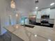 Modern kitchen island featuring quartz countertops, stainless steel appliances and pendant lighting at 263 Oak Lane Trak, Ocala, FL 34472