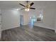 Bright living room featuring gray flooring, a ceiling fan, and a view of the open kitchen at 263 Oak Lane Trak, Ocala, FL 34472