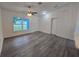 Bright living room with hard surface floors, a ceiling fan, and a white front door at 263 Oak Lane Trak, Ocala, FL 34472