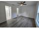 The bedroom has hard surface floors, and a ceiling fan, with an open en suite bathroom at 263 Oak Lane Trak, Ocala, FL 34472