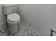 A standard toilet sits on the elegant tile floor in this well-lit bathroom at 263 Oak Lane Trak, Ocala, FL 34472
