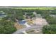 Aerial view of a home in a neighborhood, fenced in, with adjacent plot under construction at 28 Olive Dr, Ocala, FL 34472