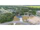 Aerial image featuring the home, driveway, a wooden fence, and surrounding greenery in a serene setting at 28 Olive Dr, Ocala, FL 34472