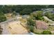 Overhead view showing a new home and nearby construction lot in a neighborhood filled with mature trees at 28 Olive Dr, Ocala, FL 34472