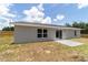 Spacious backyard with new concrete patio and modern exterior at 28 Olive Dr, Ocala, FL 34472