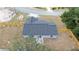 Aerial view of a house featuring a gray roof, surrounded by a wooden fence and a well-maintained lawn at 28 Olive Dr, Ocala, FL 34472