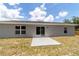 Backyard featuring concrete patio, sliding glass doors, and freshly painted exterior at 28 Olive Dr, Ocala, FL 34472