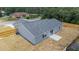Aerial view of a home's backyard showcasing a well-maintained lawn, patio, and wooden fence at 28 Olive Dr, Ocala, FL 34472