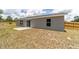 A view of the backyard with a concrete patio and a wooden fence, providing a private outdoor space at 28 Olive Dr, Ocala, FL 34472