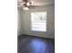 Bedroom features wood-look flooring, natural light, and a ceiling fan at 28 Olive Dr, Ocala, FL 34472