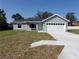 Charming single-story home features a gray exterior, white trim, and a spacious two-car garage at 28 Olive Dr, Ocala, FL 34472