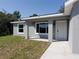 Charming single-story home features a gray exterior, white trim, and a covered entrance at 28 Olive Dr, Ocala, FL 34472