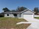 Charming single-story home features a gray exterior, white trim, and a spacious two-car garage at 28 Olive Dr, Ocala, FL 34472