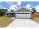 Charming one-story home boasts a modern two-car garage and a freshly paved driveway at 28 Olive Dr, Ocala, FL 34472