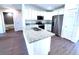 Modern kitchen featuring white cabinets, granite countertops, and stainless steel appliances at 28 Olive Dr, Ocala, FL 34472