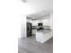 Bright kitchen features granite countertops, stainless steel appliances, and grey wood flooring at 28 Olive Dr, Ocala, FL 34472
