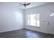 Bright and airy living room with new grey wood flooring and a large window at 28 Olive Dr, Ocala, FL 34472