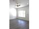 Open concept living room with grey wood flooring and new ceiling fan at 28 Olive Dr, Ocala, FL 34472