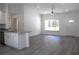 Open concept living room with large window, fan, and kitchen peninsula at 28 Olive Dr, Ocala, FL 34472