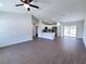 Bright open-concept living space with hardwood floors adjoining a kitchen with white cabinets at 28 Olive Dr, Ocala, FL 34472