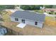 New home featuring a back patio and gray exterior, surrounded by a wooden fence at 28 Olive Dr, Ocala, FL 34472