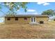 Backyard view showcasing the home's exterior and a well-maintained lawn at 31 Palm Rd, Ocala, FL 34472