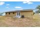 Backyard exterior of house has a small concrete patio and air conditioning unit at 31 Palm Rd, Ocala, FL 34472