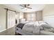 Comfortable bedroom with wood-look floors, a ceiling fan, and natural light from the window at 31 Palm Rd, Ocala, FL 34472