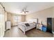 Bright bedroom with wood-look floors, ceiling fan, and a window that provides natural light at 31 Palm Rd, Ocala, FL 34472
