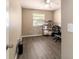 Office features a ceiling fan, wood-look floors, and natural light from the window at 31 Palm Rd, Ocala, FL 34472