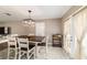 Dining area featuring a rustic table, access to the backyard, and a bar cart for entertaining at 31 Palm Rd, Ocala, FL 34472