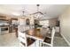 Spacious dining area with a large wooden table, modern lighting, and open access to living spaces at 31 Palm Rd, Ocala, FL 34472