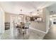 Bright dining area featuring a rustic wood table, white chairs, and modern lighting fixtures at 31 Palm Rd, Ocala, FL 34472