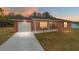 Charming brick home with a screened porch and a freshly painted driveway at 31 Palm Rd, Ocala, FL 34472