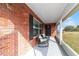 Inviting screened front porch with rocking chairs, perfect for relaxing outdoors at 31 Palm Rd, Ocala, FL 34472