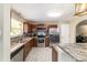 Well-equipped kitchen with stainless steel appliances, dark wood cabinets, and sleek countertops at 31 Palm Rd, Ocala, FL 34472