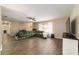 Bright living room with an oversized sectional and modern ceiling fan at 31 Palm Rd, Ocala, FL 34472