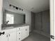 Spacious bathroom with double vanity, granite countertop, and a walk-in shower at 4162 Sw Gardenia Ct, Dunnellon, FL 34431