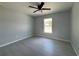 Comfortable bedroom with a ceiling fan, tile flooring, and a bright window at 4162 Sw Gardenia Ct, Dunnellon, FL 34431