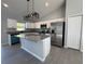 Bright open kitchen with granite counters, white cabinets, stainless appliances, and modern lighting at 4162 Sw Gardenia Ct, Dunnellon, FL 34431