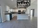 Spacious open kitchen with granite counters, white cabinets, stainless appliances, and modern lighting at 4162 Sw Gardenia Ct, Dunnellon, FL 34431