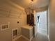 Well-lit laundry room with utility sink, hookups and shelving at 4162 Sw Gardenia Ct, Dunnellon, FL 34431