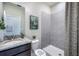 Bright bathroom featuring patterned shower curtains, grey tiling, and a vanity sink at 4164 Sw 53Rd Lane Rd, Ocala, FL 34474
