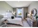 Inviting bedroom with modern decor, dresser with decorative mirror and calming lake view at 4164 Sw 53Rd Lane Rd, Ocala, FL 34474